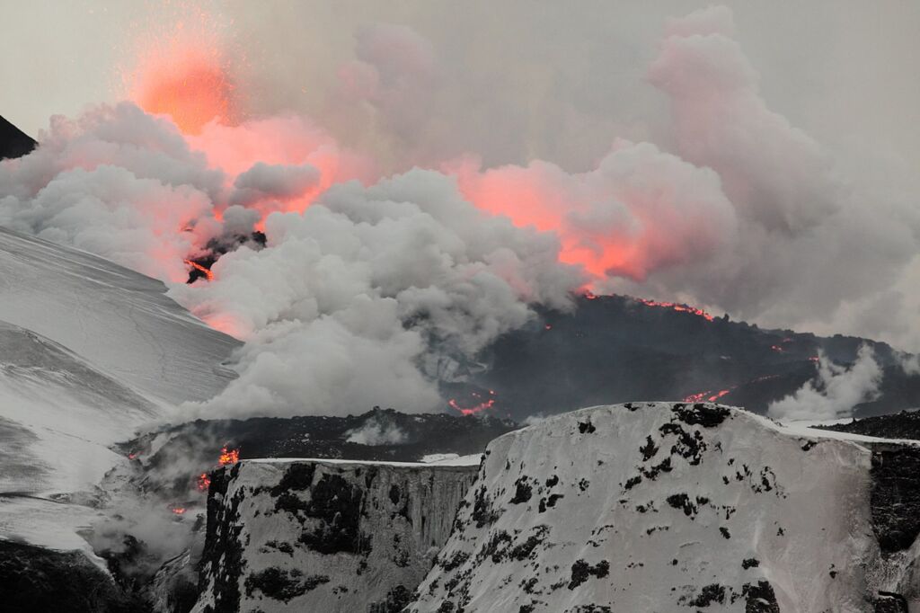 Photo showing the 2nd fissure on Fimmvörðuháls, as lava flows down, turning snow into steam.