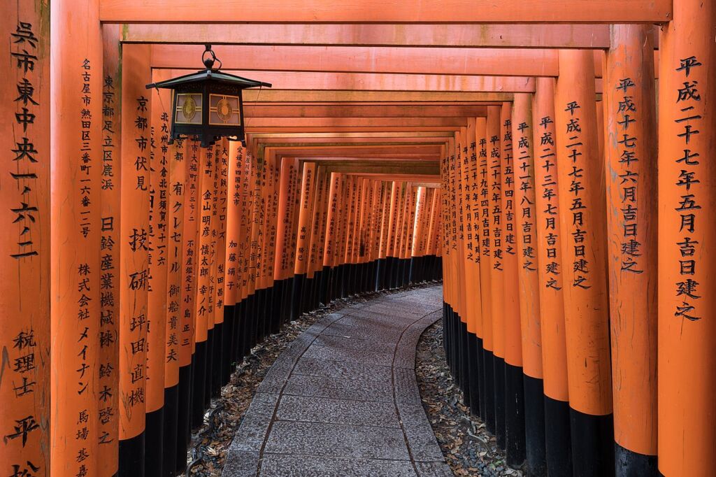 Photo showing Torii path with a hanging lantern at Fushimi Inari Taisha Shrine Senbontorii