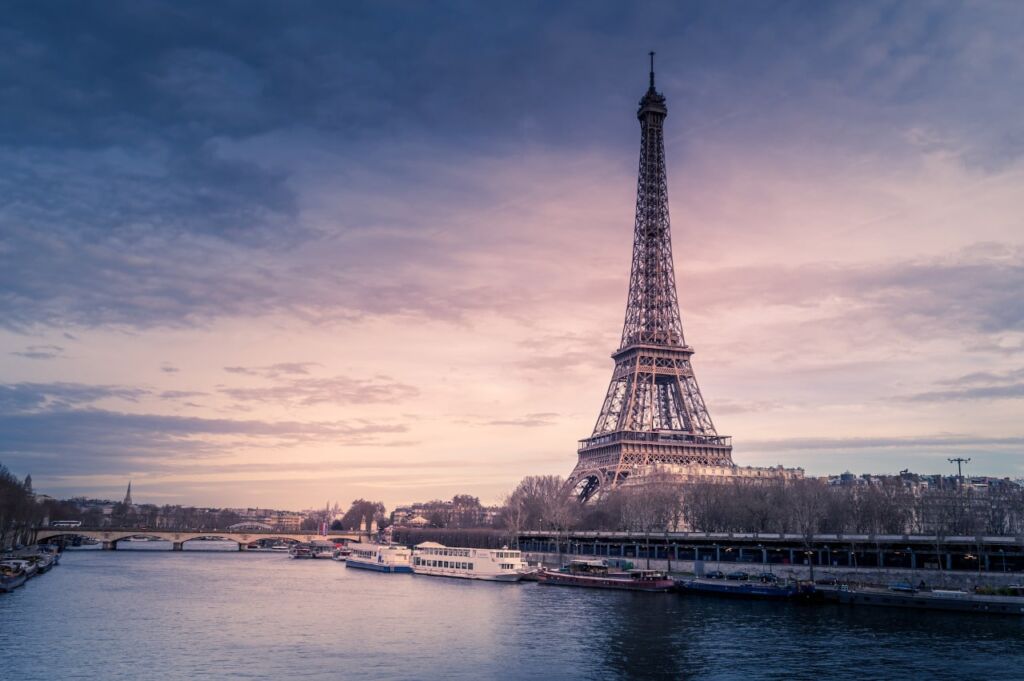 The lovely Eiffel Tower and Seine with river boats, Paris France