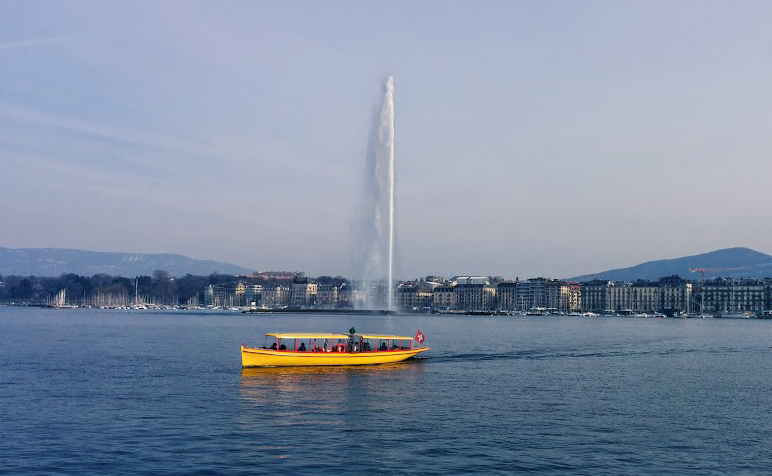 A tourist boat passes the fountain Jet d’Eau on Lake Geneva located in Geneva, Switzerland.