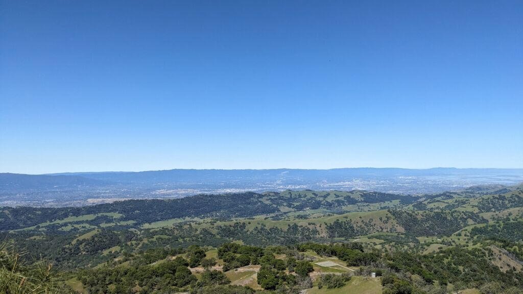 A panoramic photo of a wide valley on a sunny day.