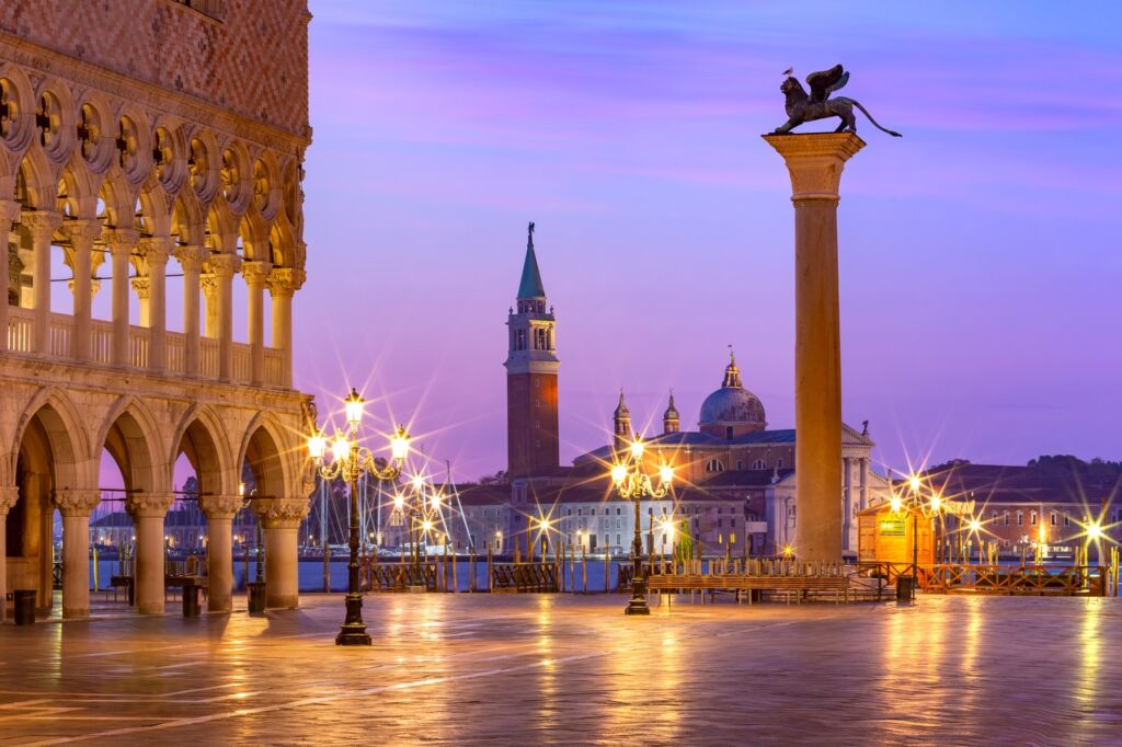 Doge Palace and Column of San Marco on Piazzeta San Marco at sunrise in Venice, Italy. San Giorgio di Maggiore on background