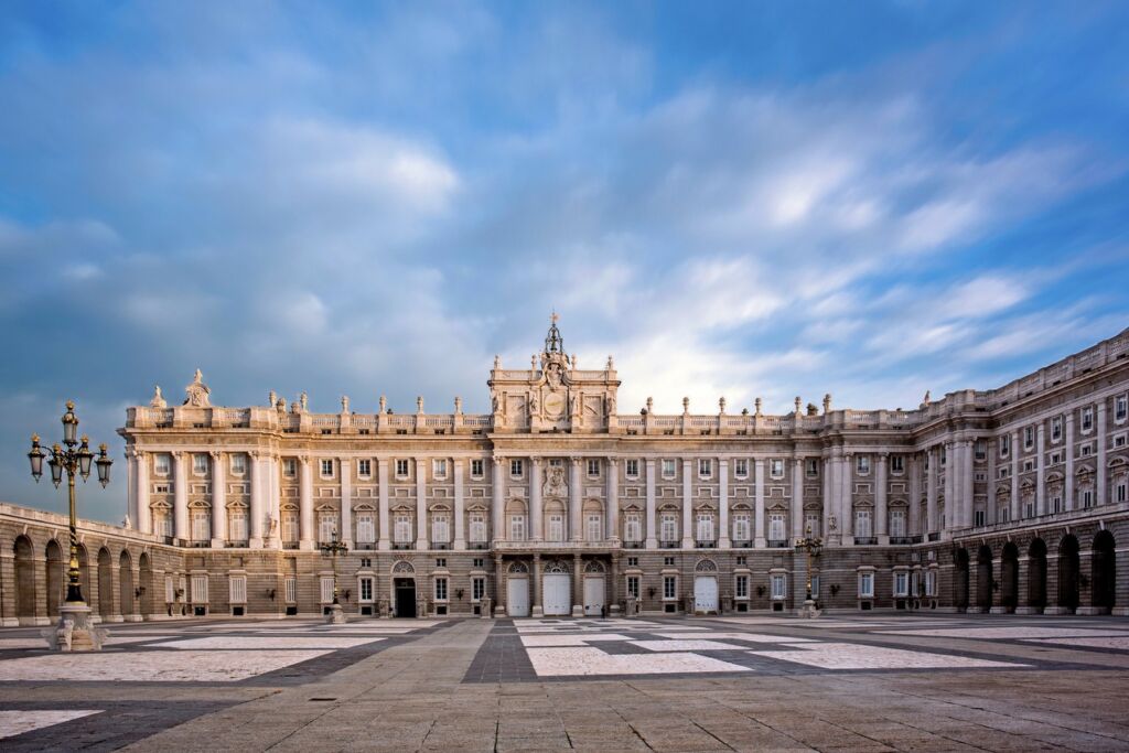 Royal Palace - Madrid, Spain with ominous clouds above, making the enigmatic palace look ominous